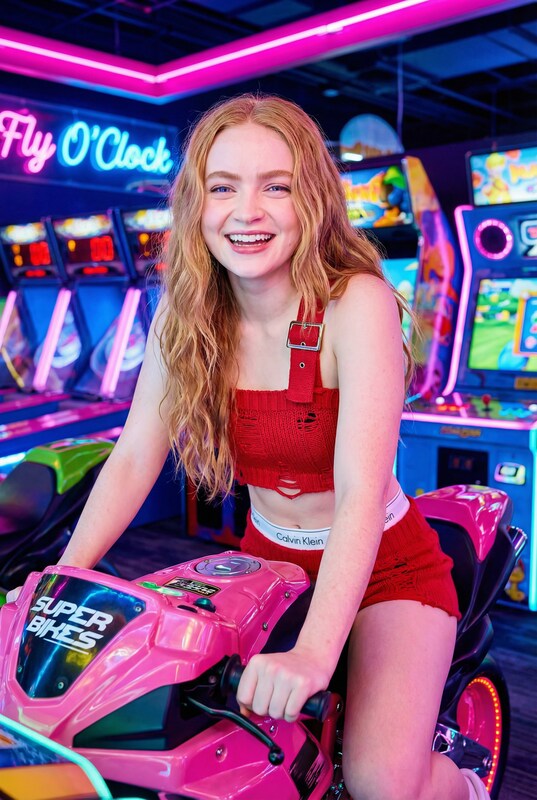 Sydney Sweeney和Sadie Sink在粉红色游戏机上的照片